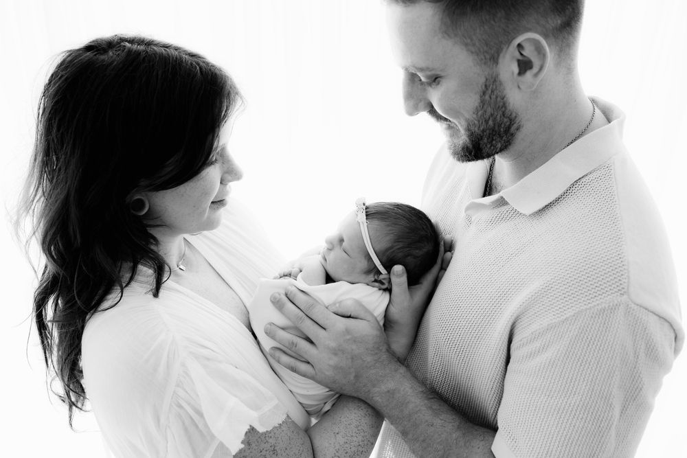 Intimate black and white portrait series showing tender moments between parent and child.