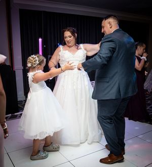 A sequence of four photos showing a couple dancing on a white dance floor during a wedding reception.