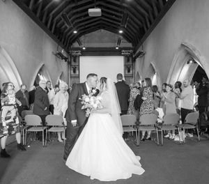 Black and white wedding reception photos showing dancing and celebration at an elegant arched venue.