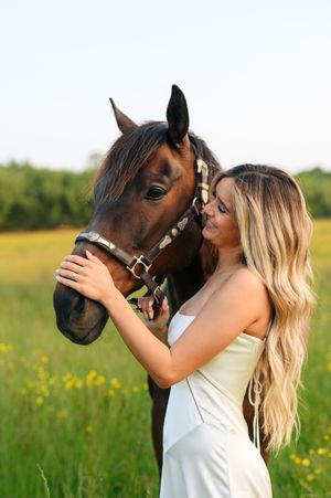 A series of images shows a woman in a white dress affectionately interacting with a brown horse in a sunny meadow.