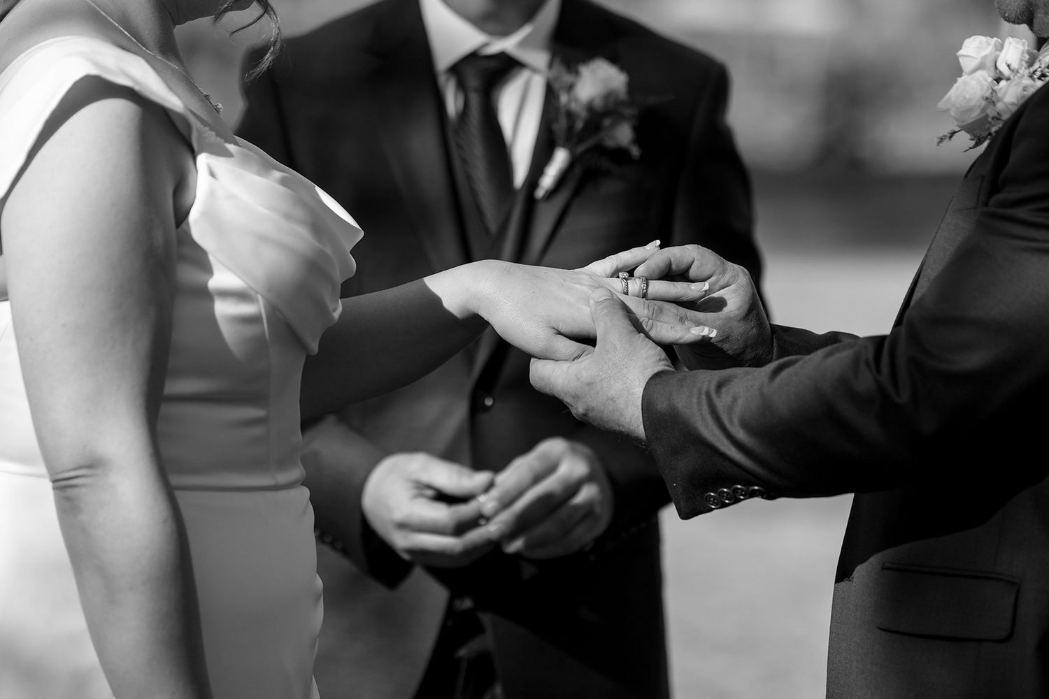 A wedding couple exchange their wedding rings during an intimate black and white ceremony moment at Buller Wines.