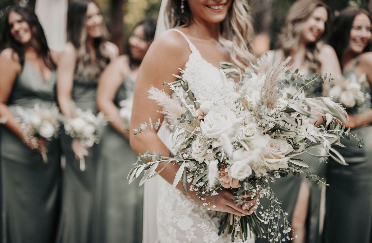 Rustic chic wedding party with groomsmen in beige suits and bridesmaids in olive green dresses