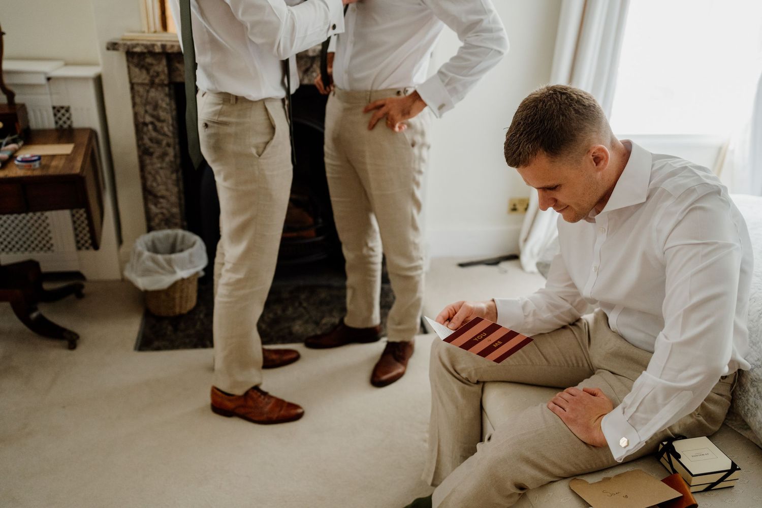 Wedding party members in white shirts gather before the ceremony.