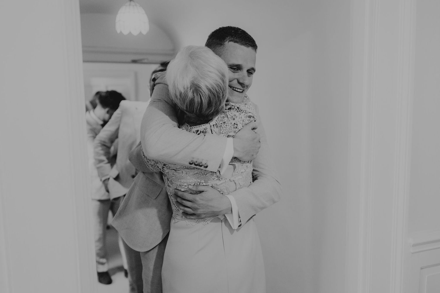 Black and white photo of pre-wedding preparations in an indoor setting.