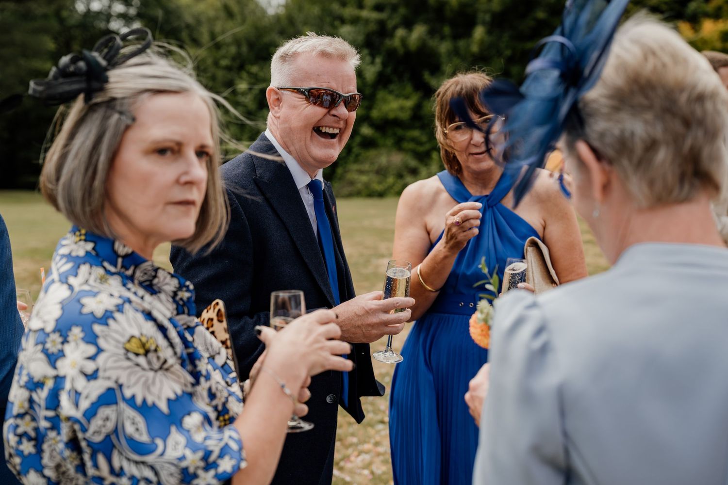 Wedding reception guests mingling and socializing outdoors.