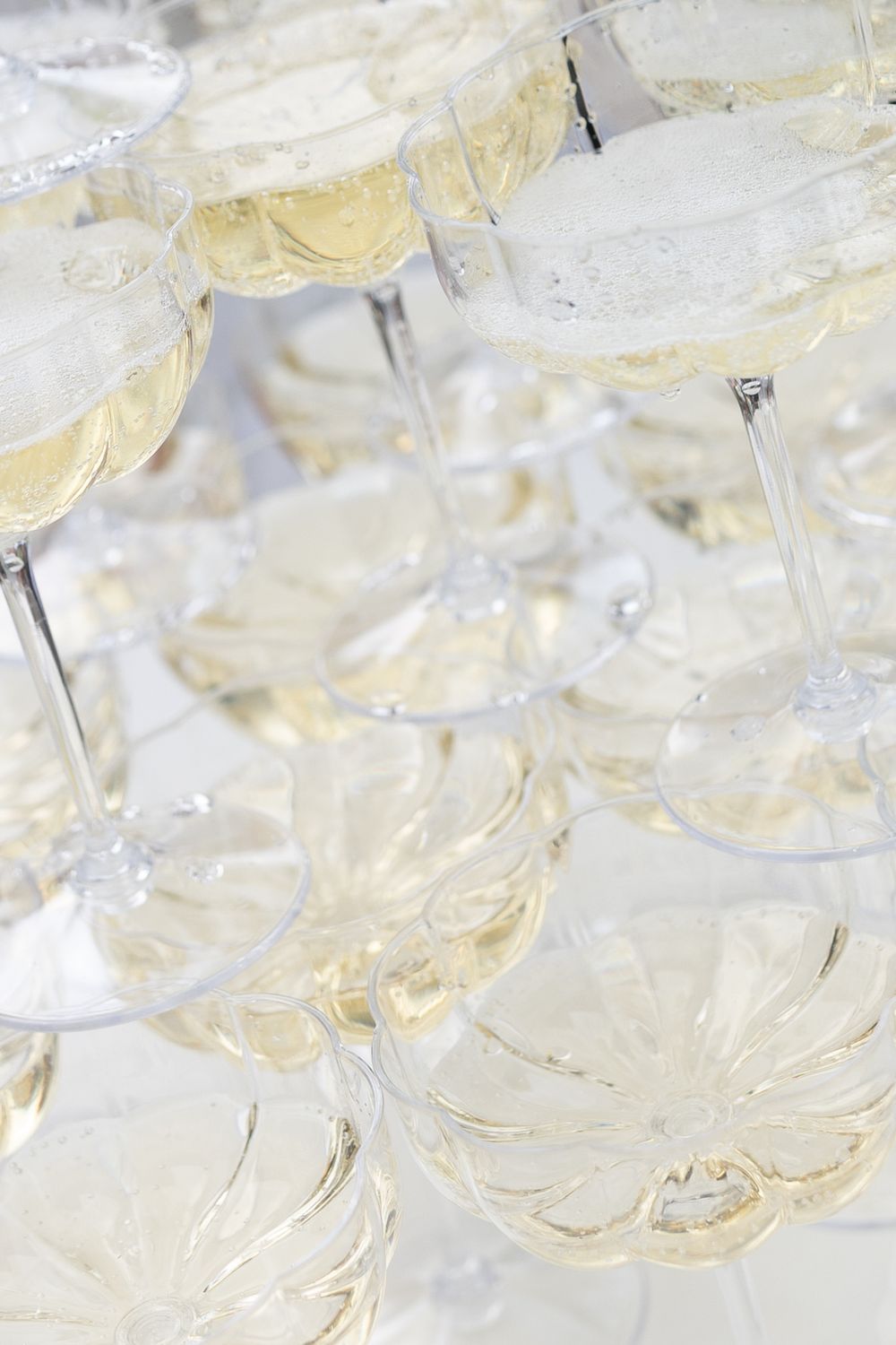 Close-up view of champagne glasses arranged in rows for a wedding toast.