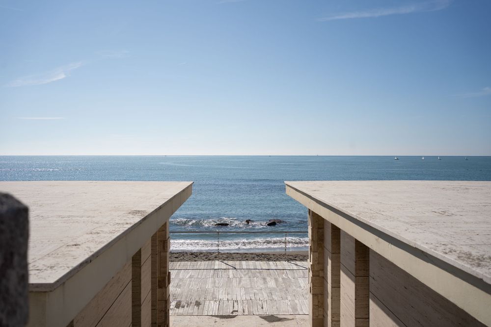 Wooden boardwalk leading to a sandy beach with ocean views.