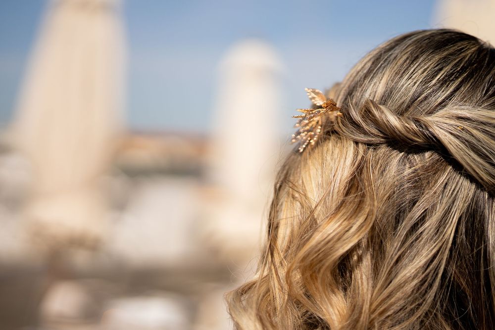 Rooftop panoramic view of an Italian city skyline with historic architecture and blue sky.