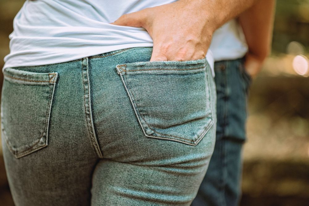Close-up of denim-clad couple in casual embrace.