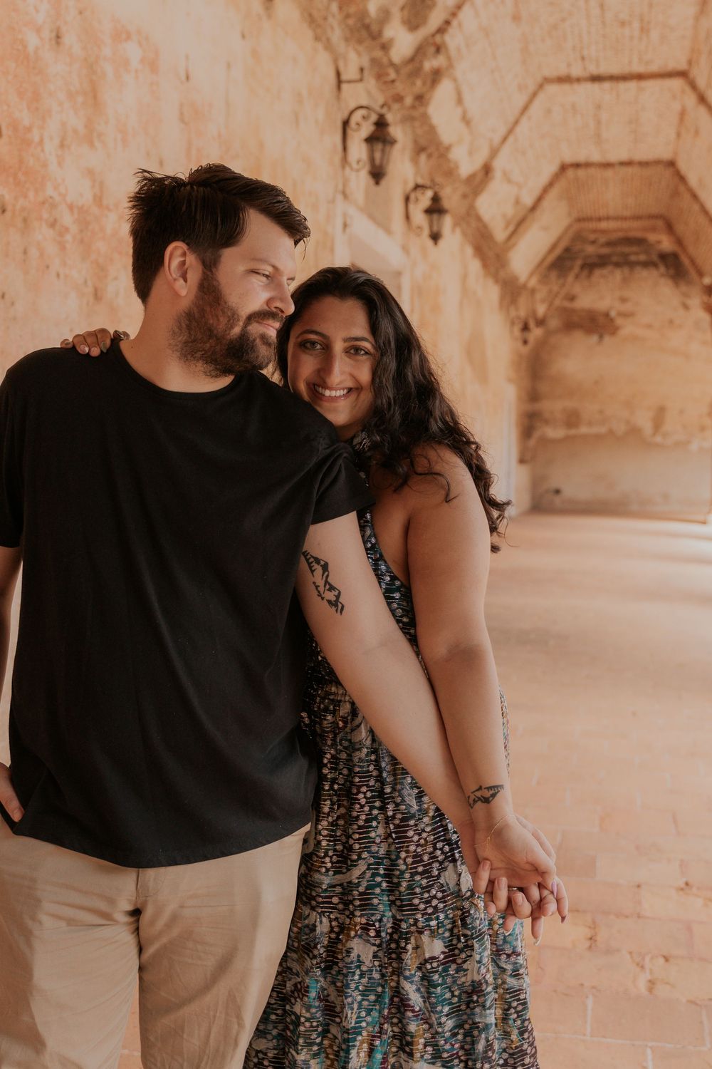 Five romantic engagement photos showing a couple embracing in a vintage courtyard setting.