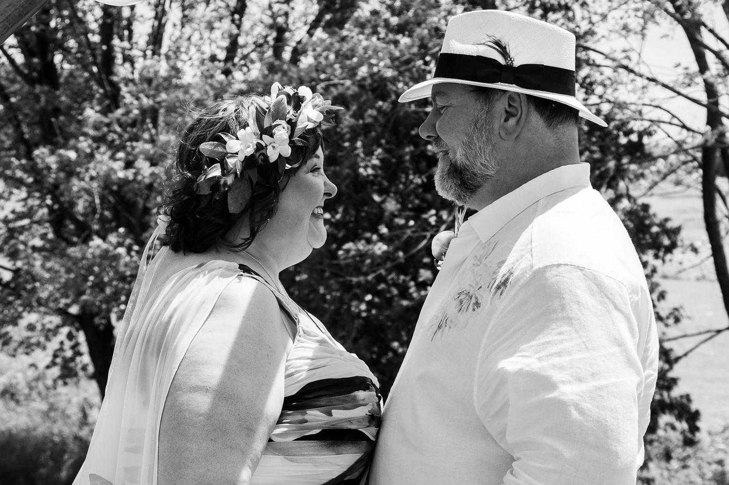 A vintage black and white photo showing a couple in conversation outdoors.