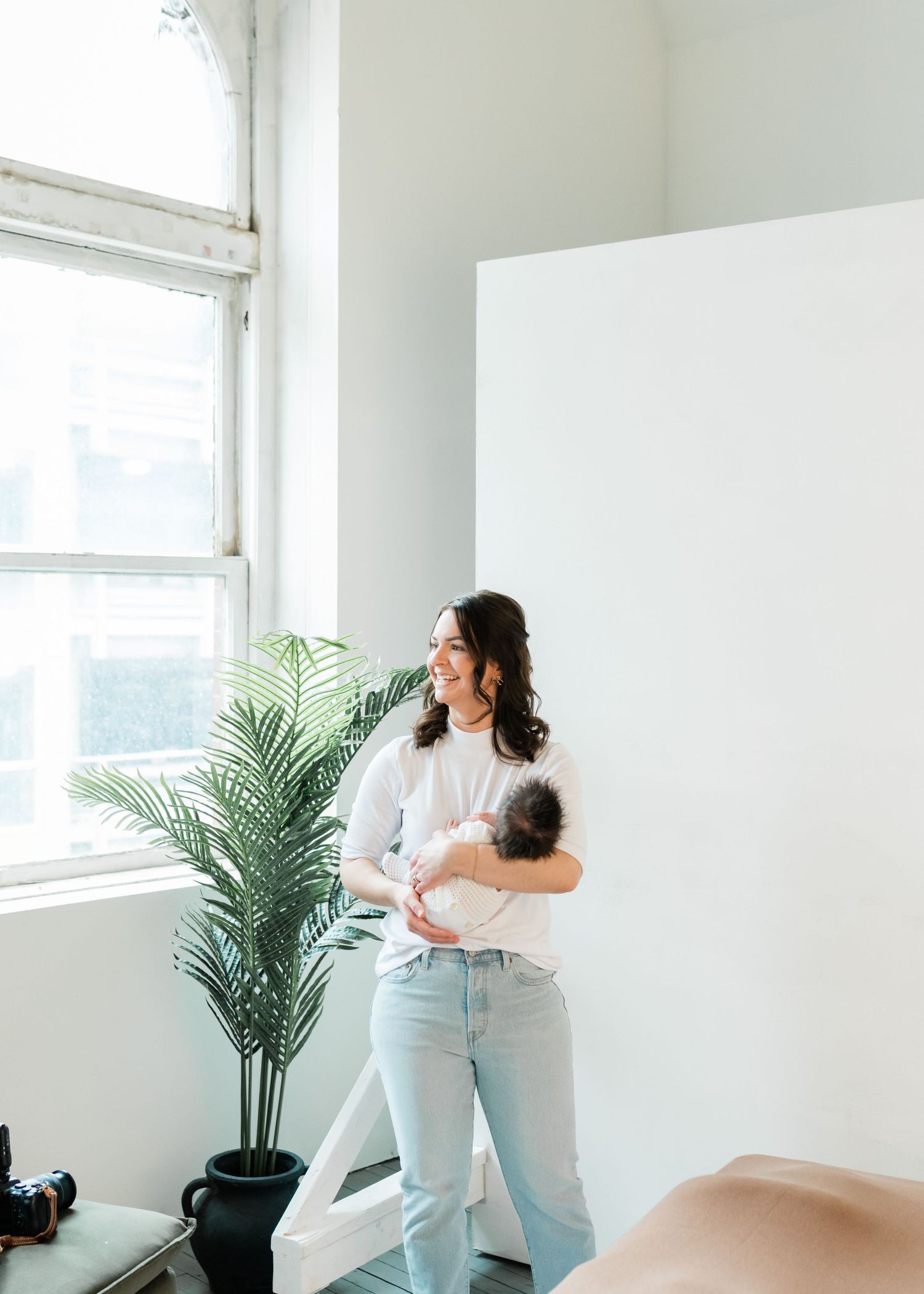 Calming a newborn during a newborn photography session.
