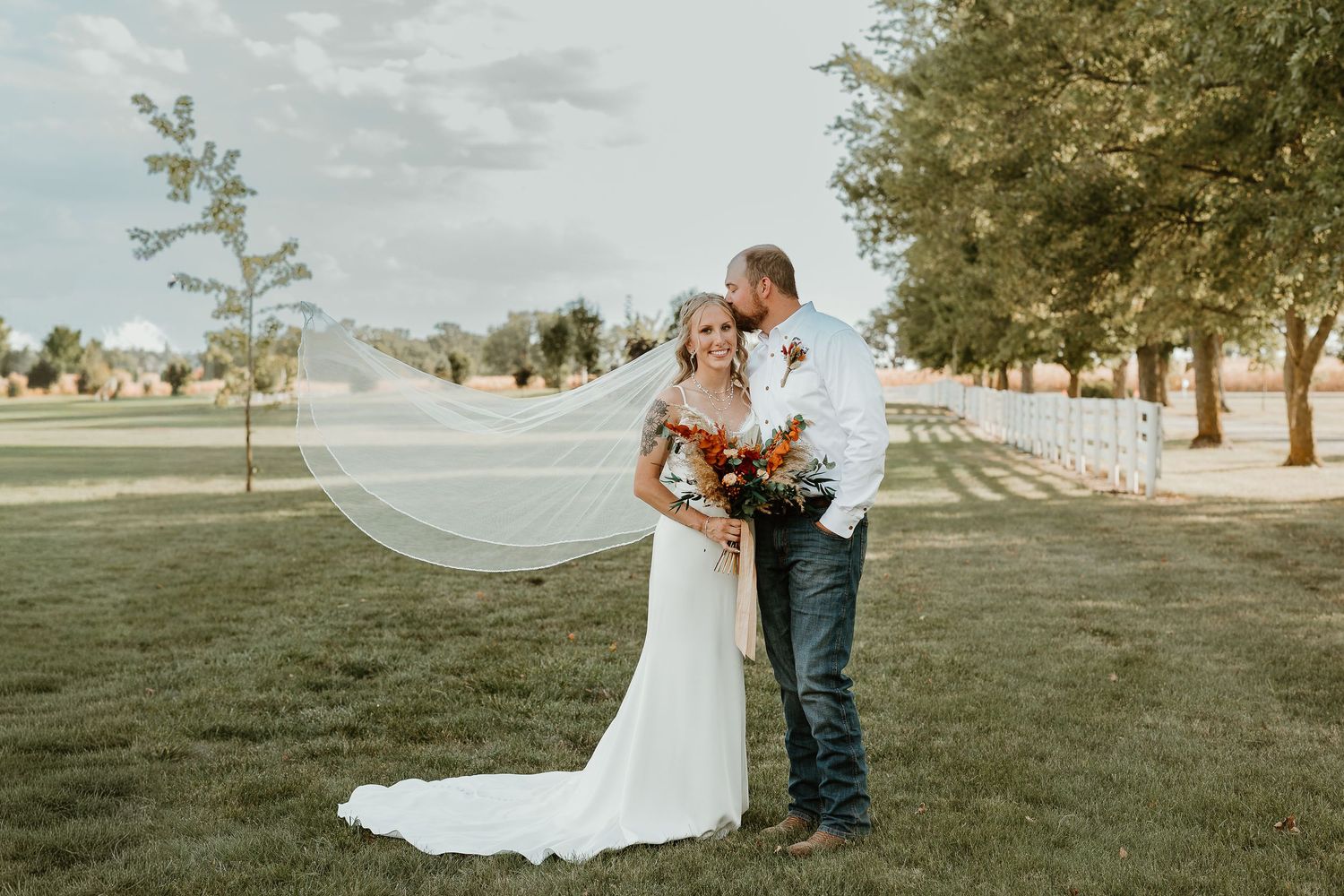 Wedding photography session featuring couples and groups by rustic farm silos.