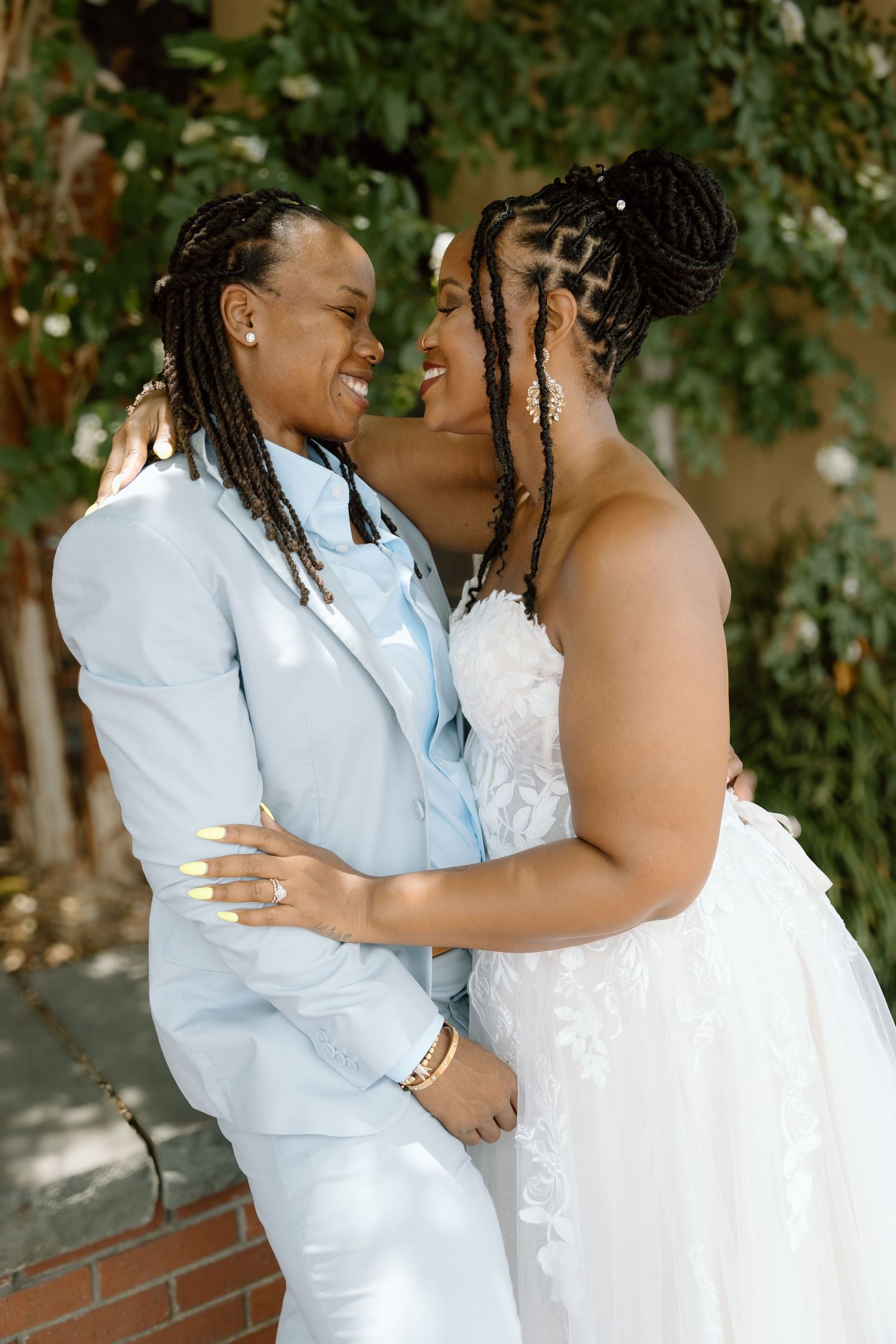LGBTQ couple holding hands after romantic courthouse elopement at blue ridge mountain overlook near Asheville, North Carolina