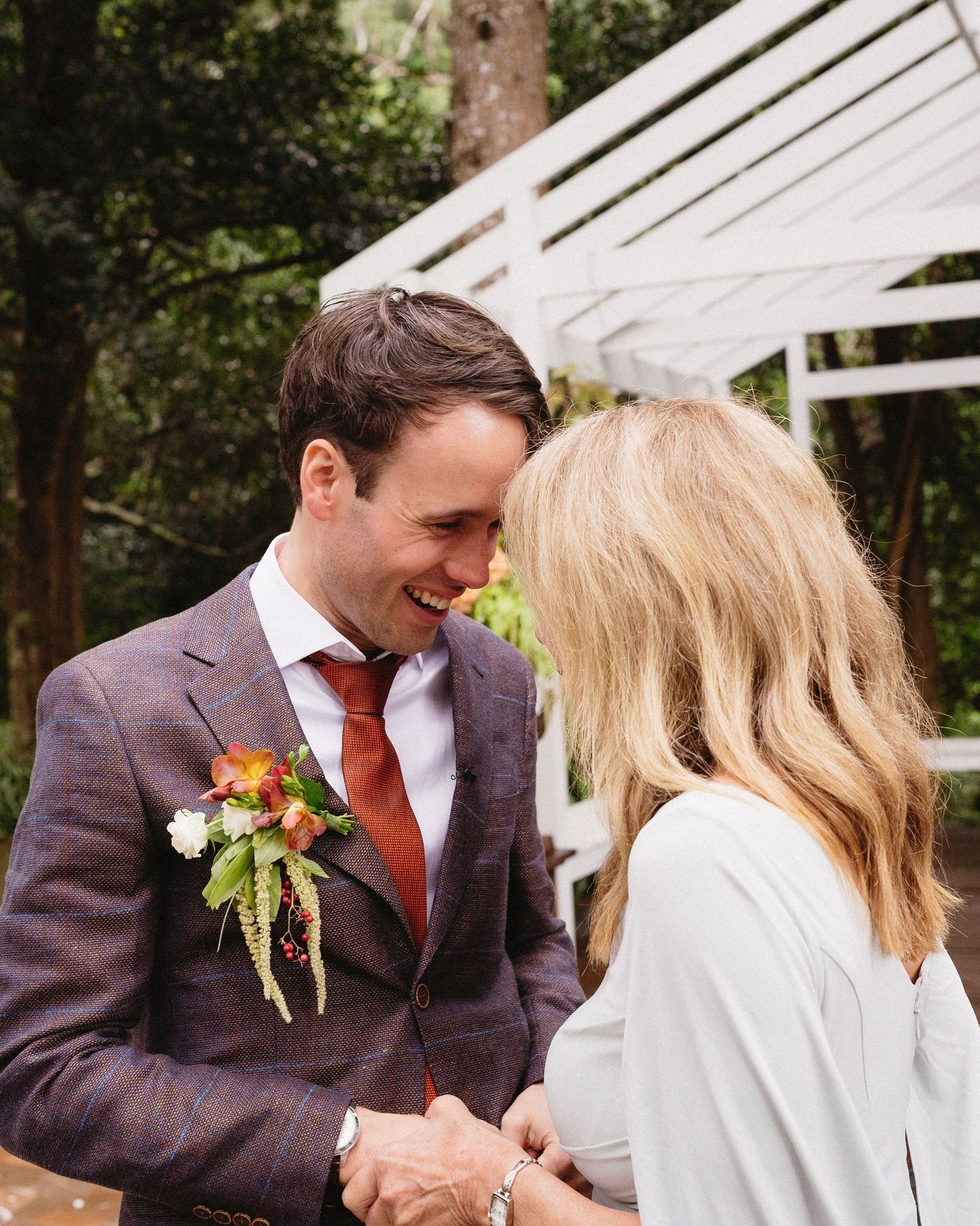 Intimate moment between couple during outdoor wedding celebration.