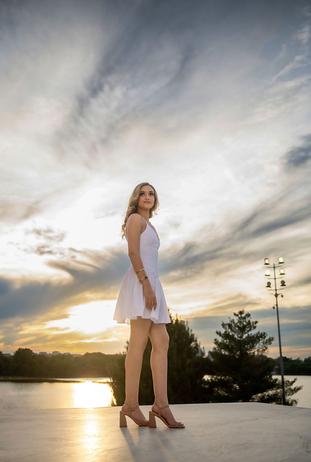 Sunset graduation photos with dramatic sky and waterfront views.