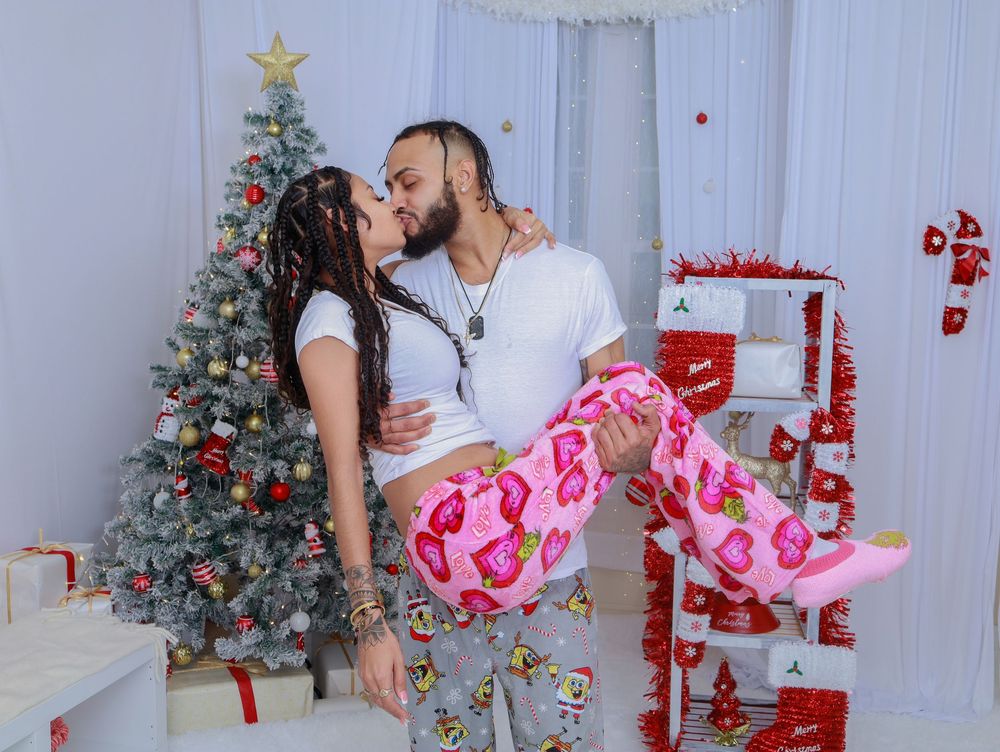 A romantic Christmas photo with a decorated tree and red and white holiday decorations.