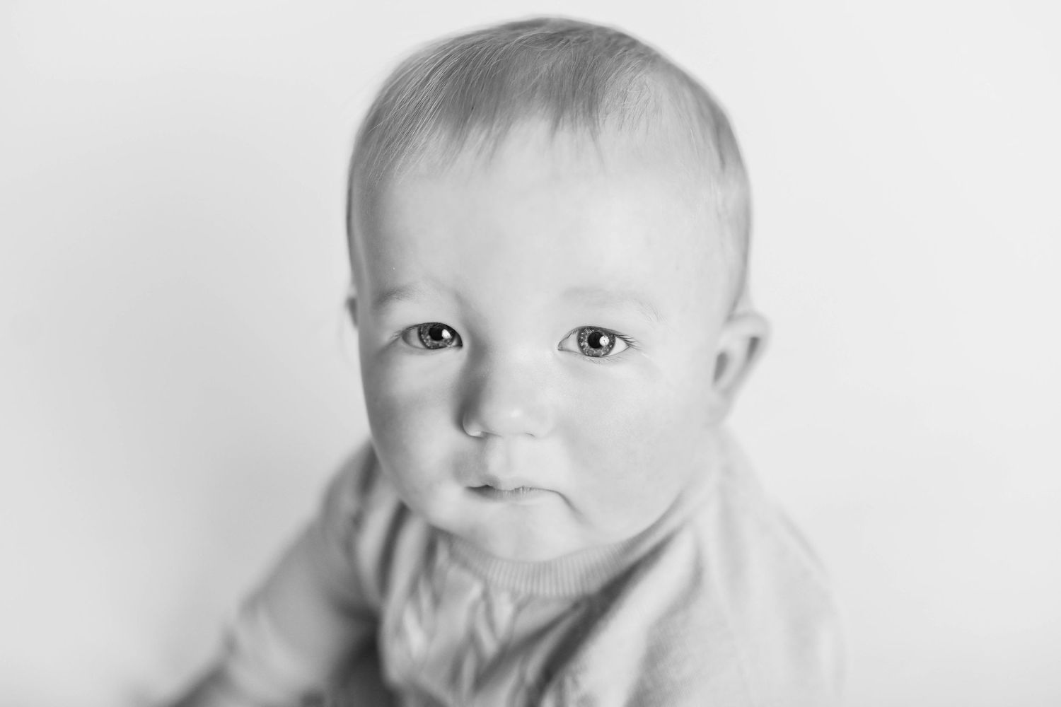 Close up black and white portrait against a light background.