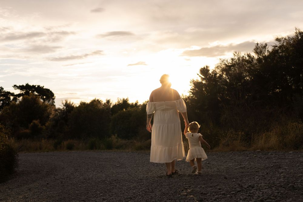 mum holding her daughters hand during motherhood session at Mcleans Island during sunset session