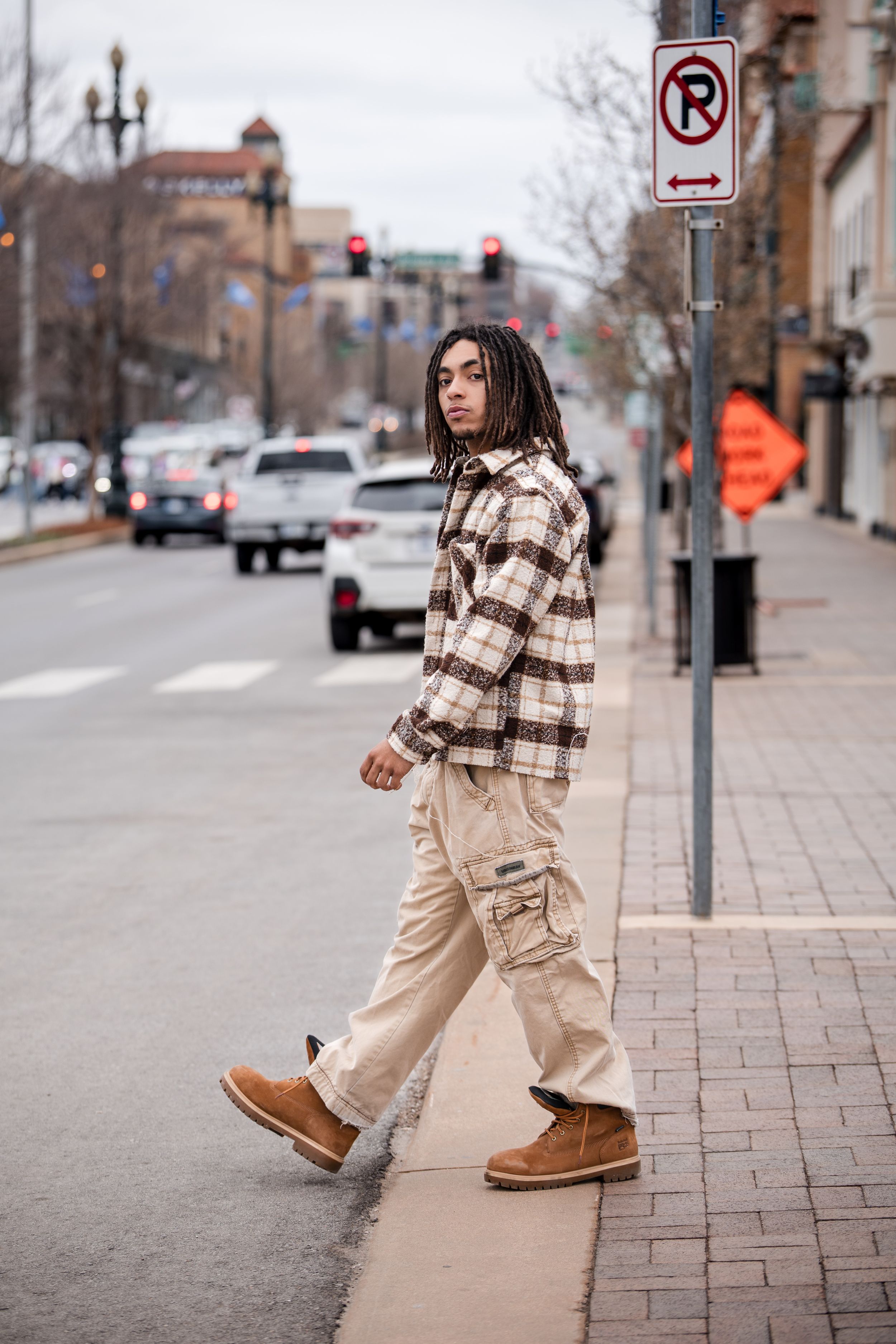 Street style photography showcasing casual winter outfit on brick sidewalk.