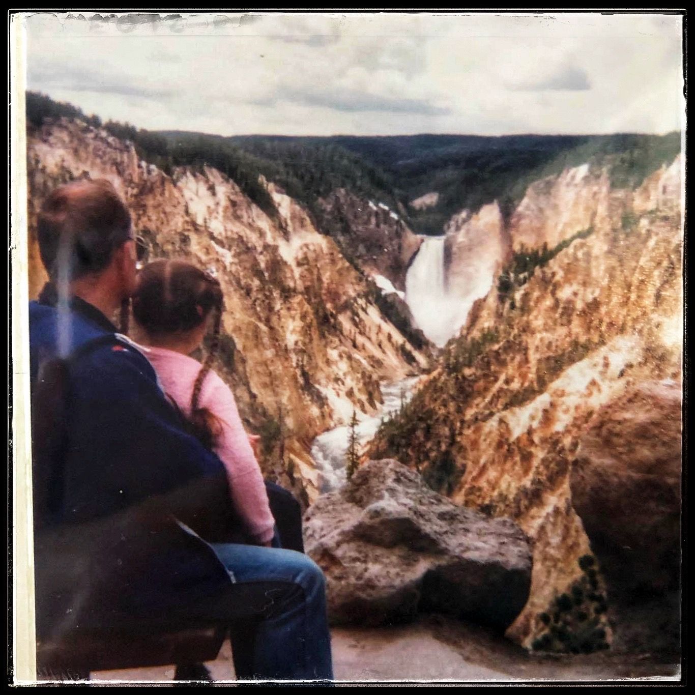 Landscape Photo of father and young daughter enjoying the scenery of Yellowstone National Park waterfall.
