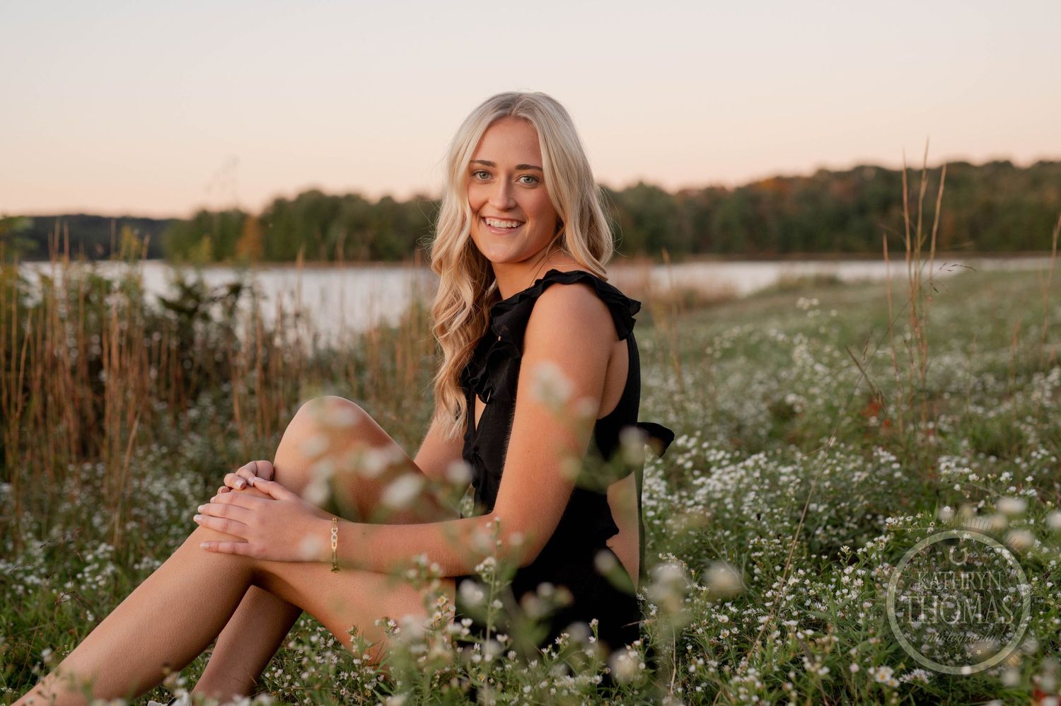 Casual outdoor portrait session in flowering field during golden hour.