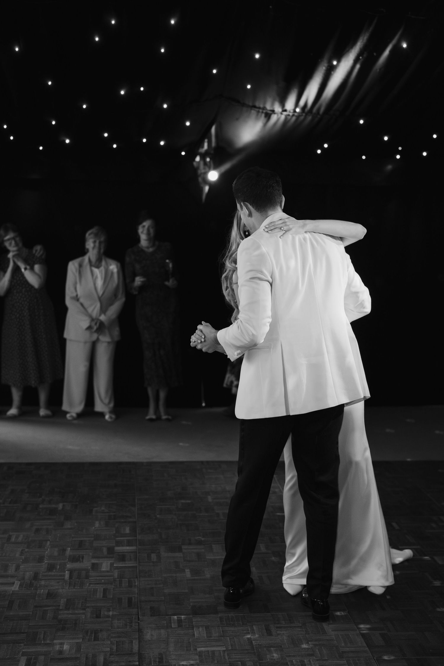 bride and groom doing their first dance surrounded by their wedding guests at hamswell house in bath