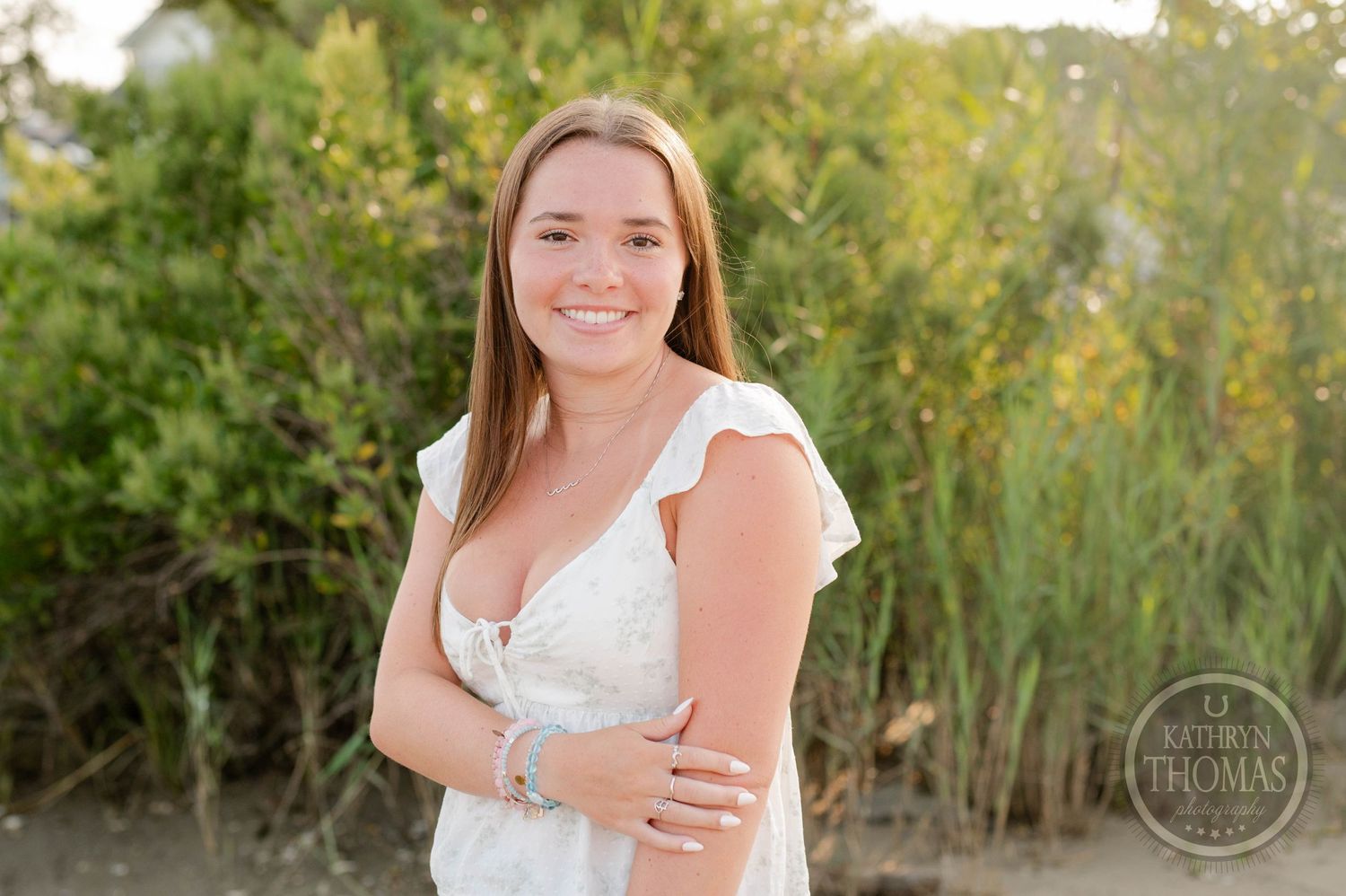 A warm summer portrait with lush greenery and golden sunlight.