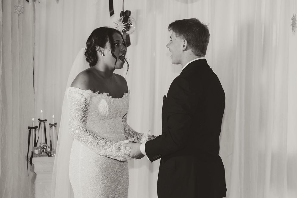 A couple shares a tender moment during their wedding photo session in black and white.