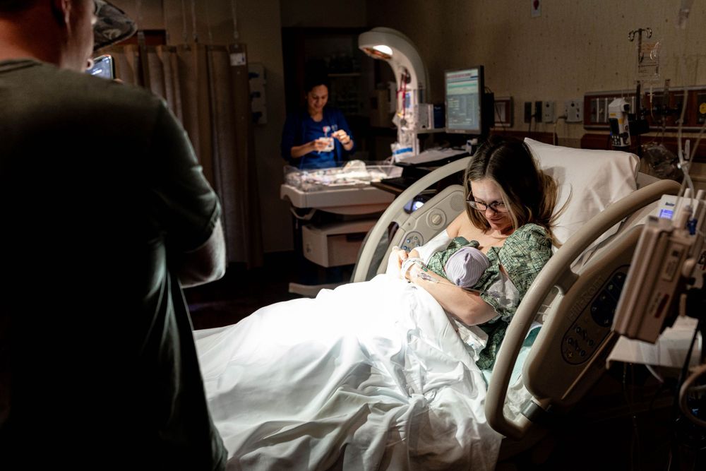 photo of mother holding newborn for the first time — Beaumont birth photographer"