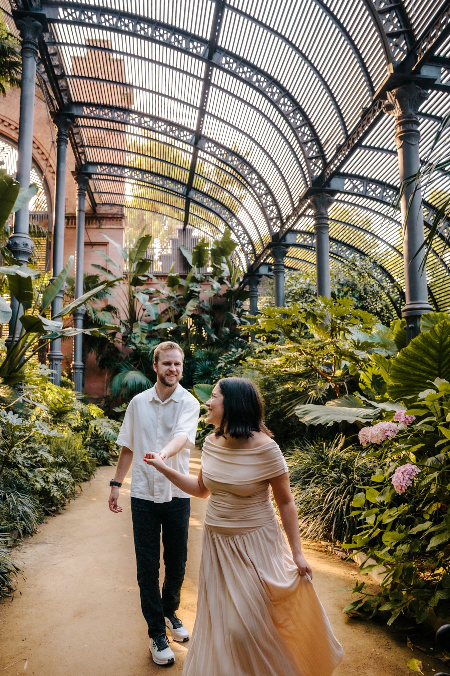 Zack & Donna smiling together surrounded by lush greenery.