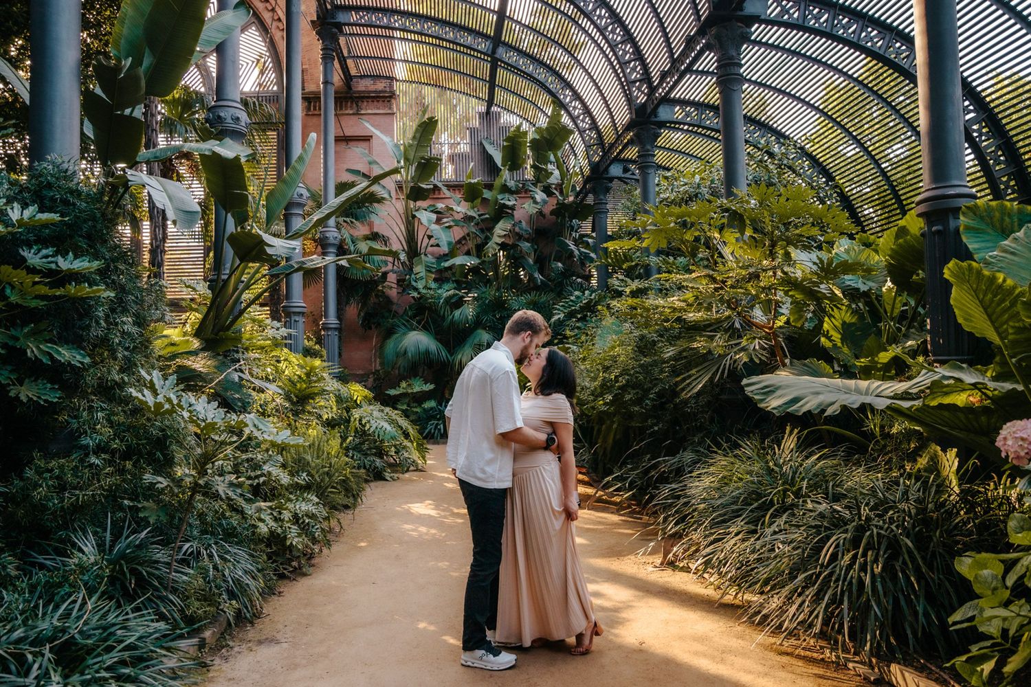 Zack & Donna smiling together surrounded by lush greenery.