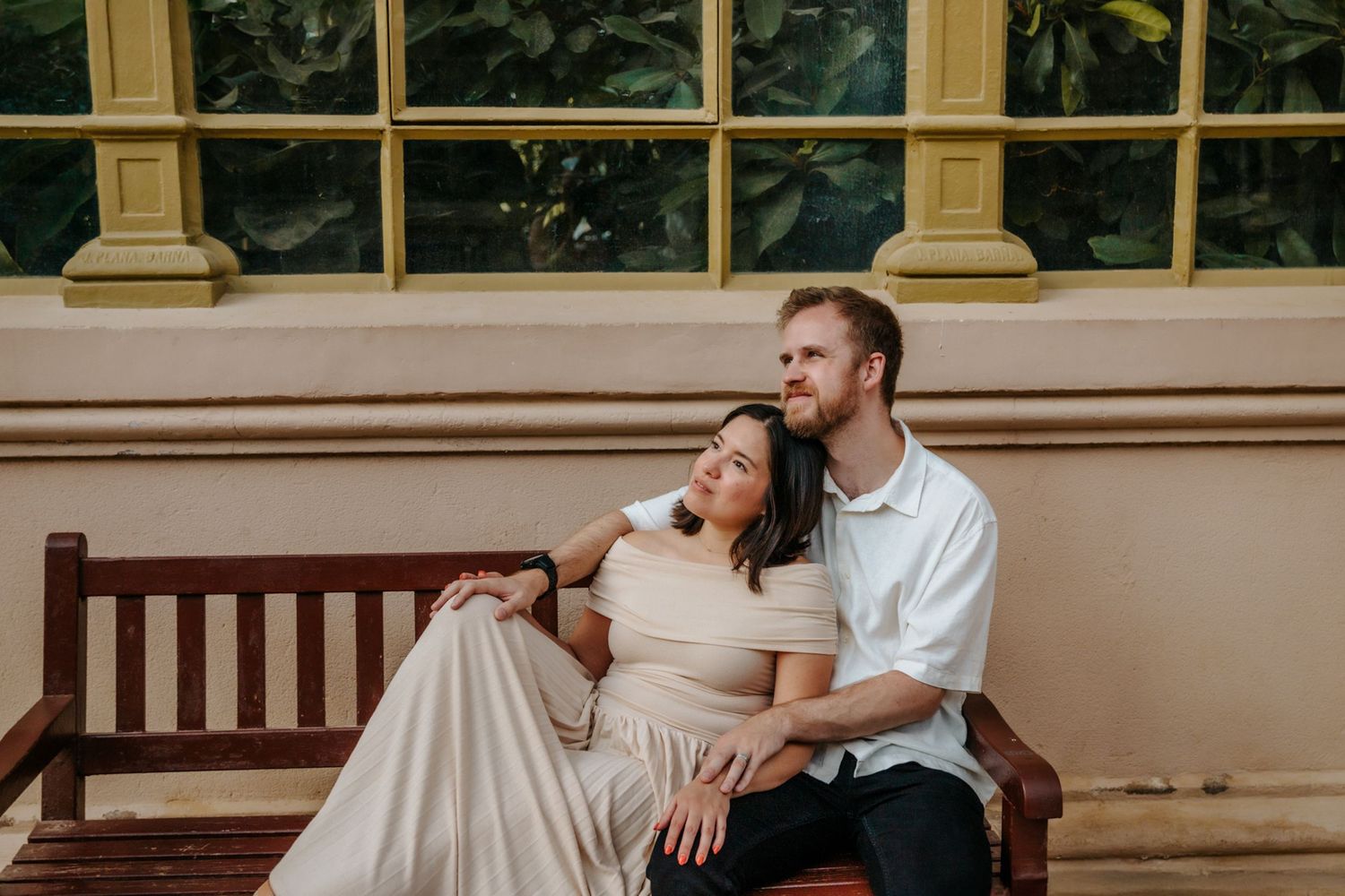 Couple gazing lovingly at each other in golden sunlight.
