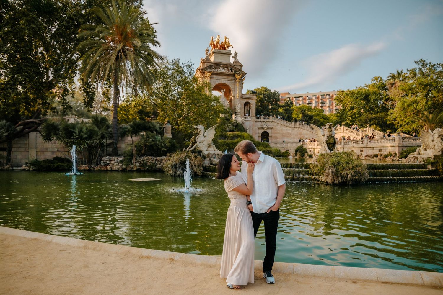 Joyful honeymoon moment captured near the historic fountain.
