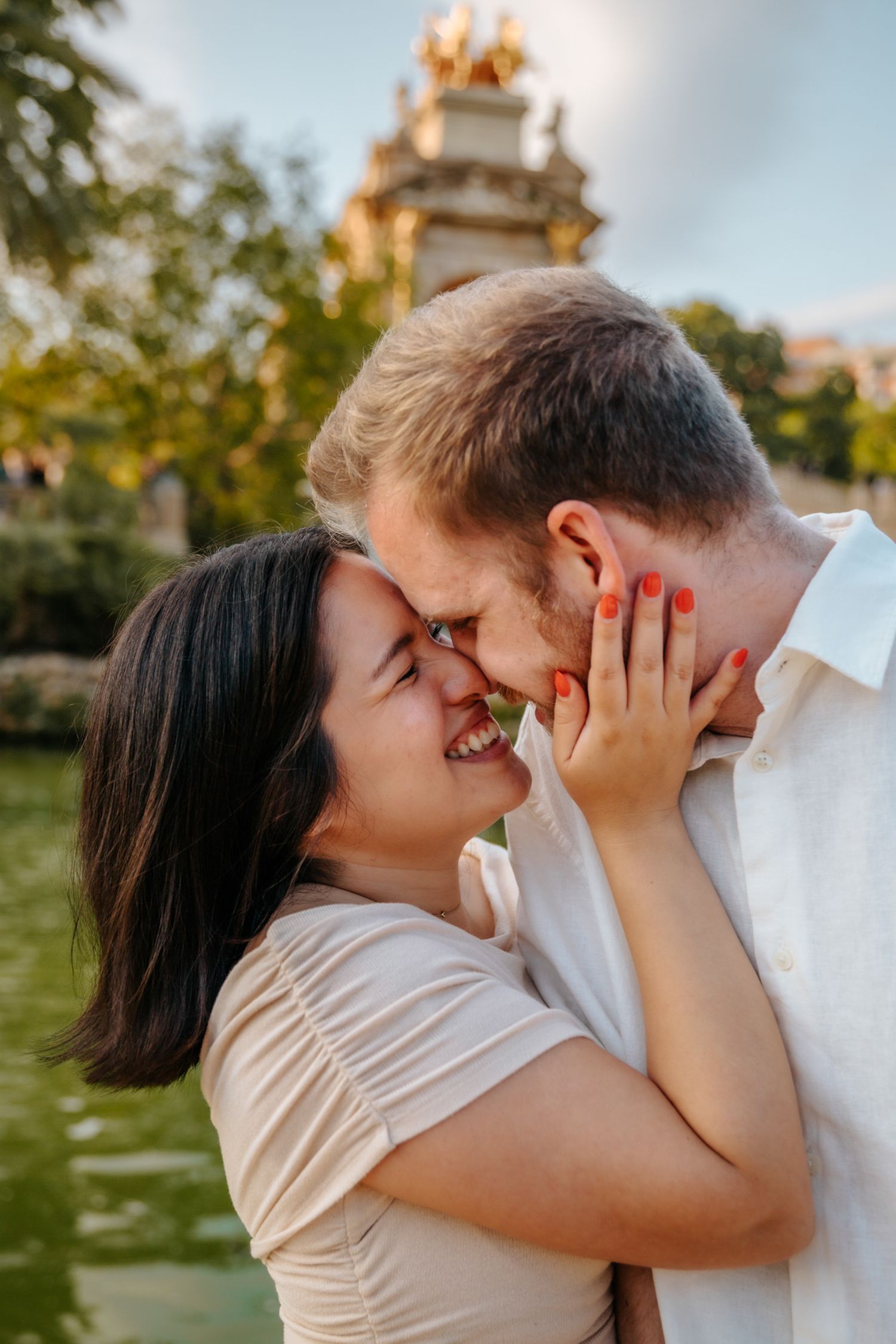 Couple laughing together under warm summer afternoon light.