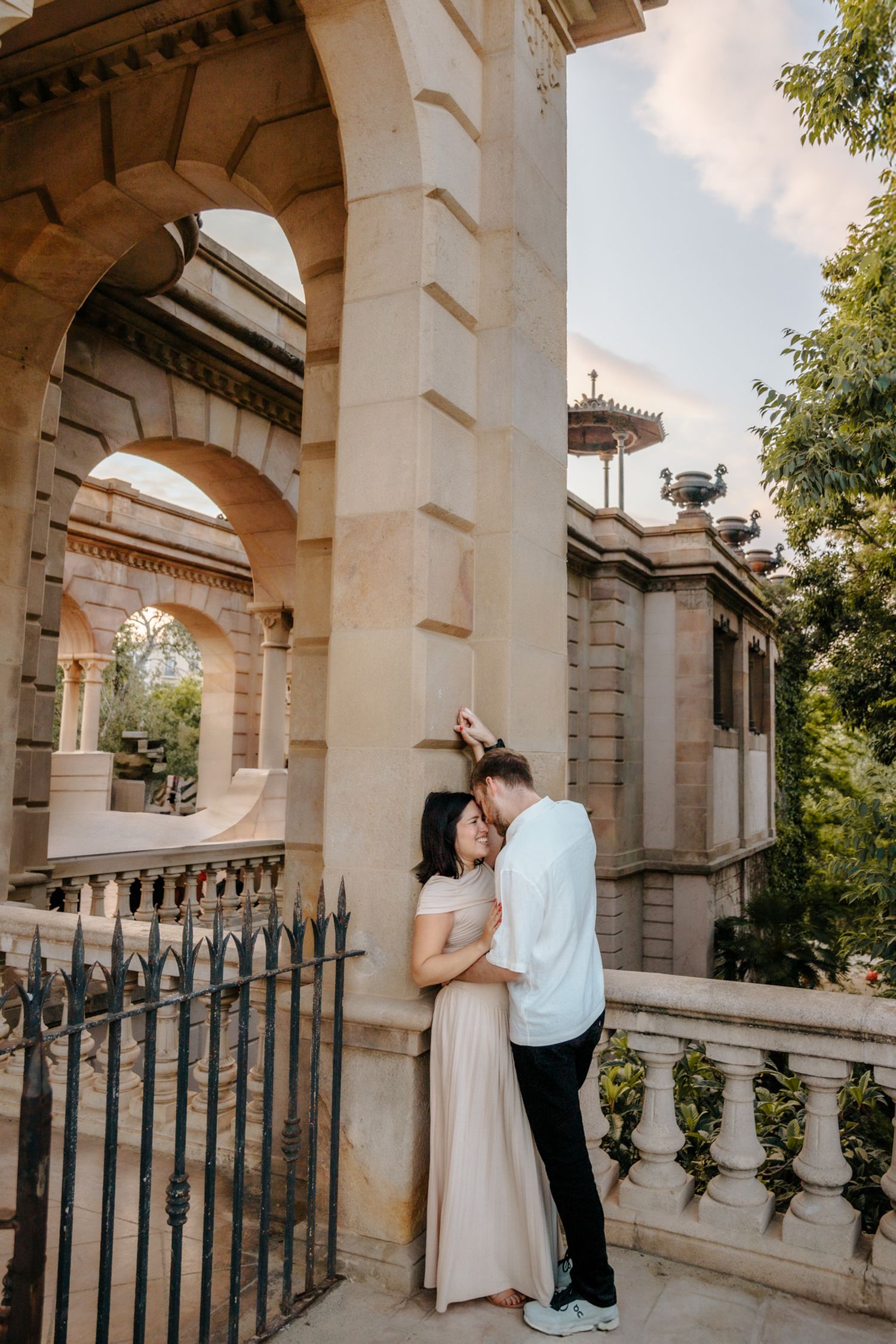 Donna glowing as Zack hugs her tenderly during their honeymoon session.