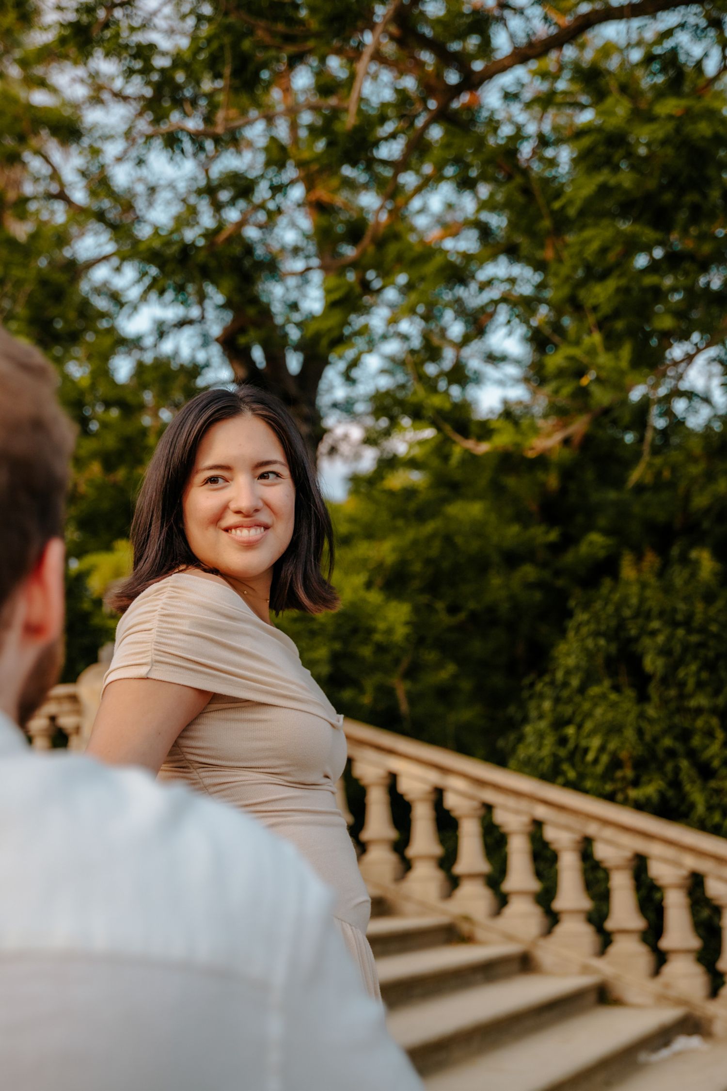 Zack & Donna smiling together during their honeymoon photoshoot in Ciutadella Park, Barcelona.