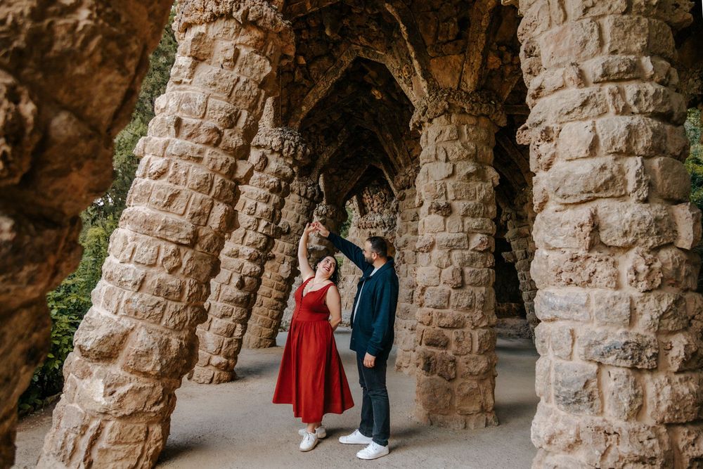 Couple holding hands tenderly on a colorful mosaic terrace.