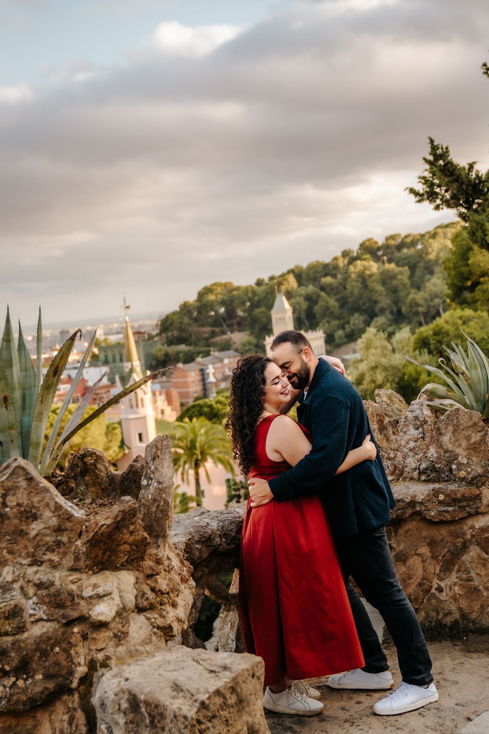 Couple gazing lovingly at each other along Park Güell’s colorful pathways.