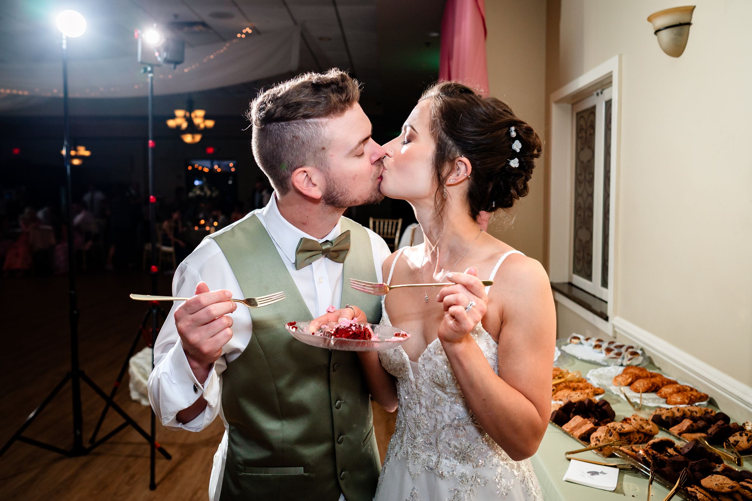 Bride and groom enjoy a fun cake-smashing moment at their wedding reception.
