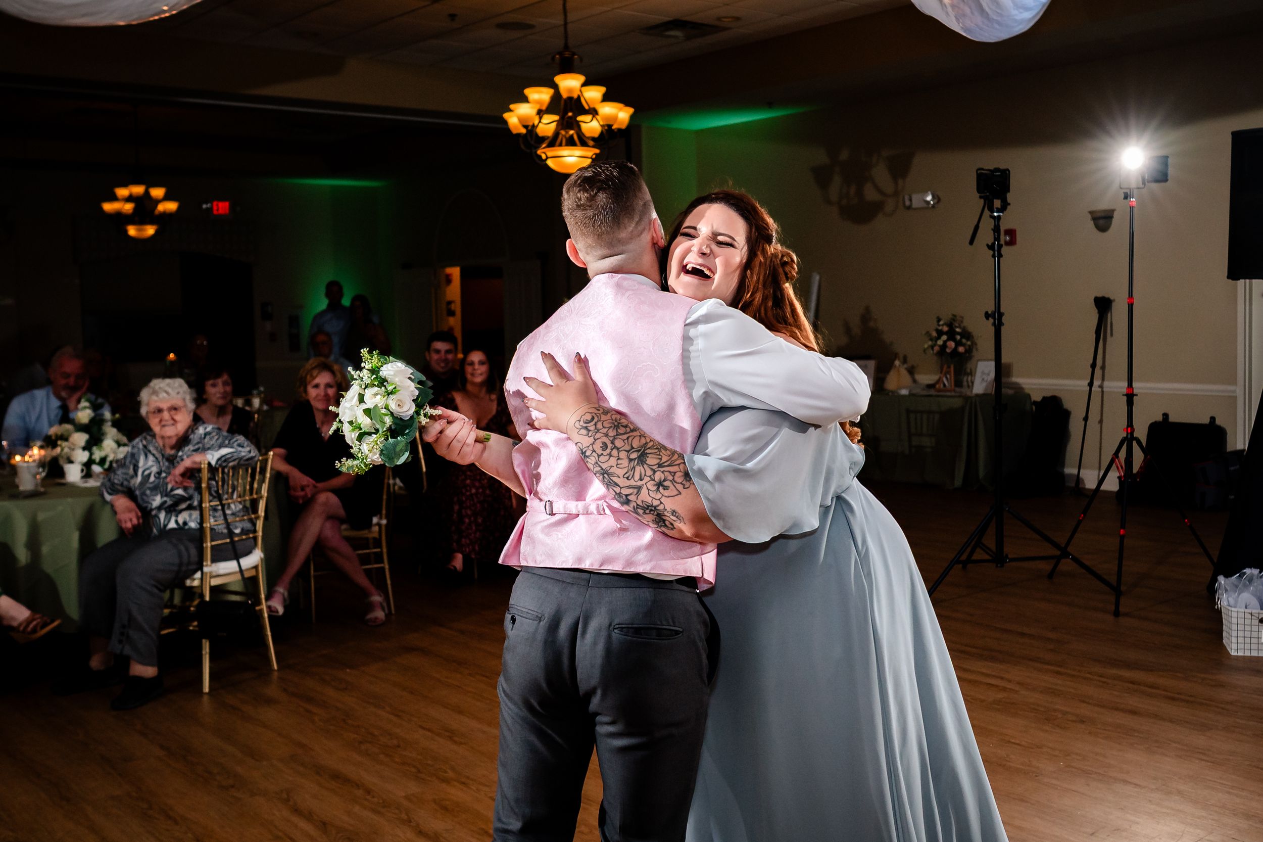 Wedding guests dance and celebrate during an evening reception party.