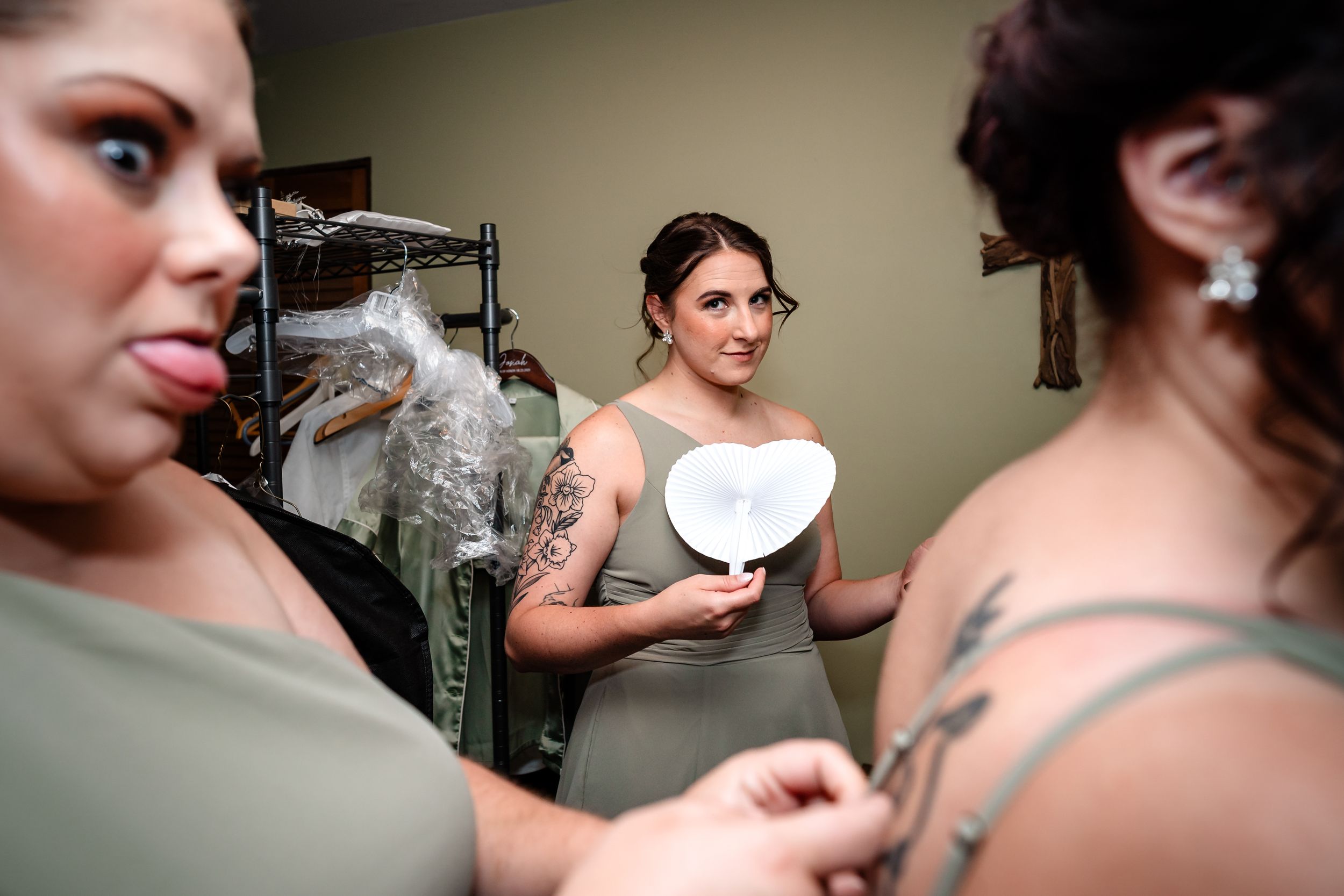 Wedding preparation scene showing final touches being made to bridal party attire.