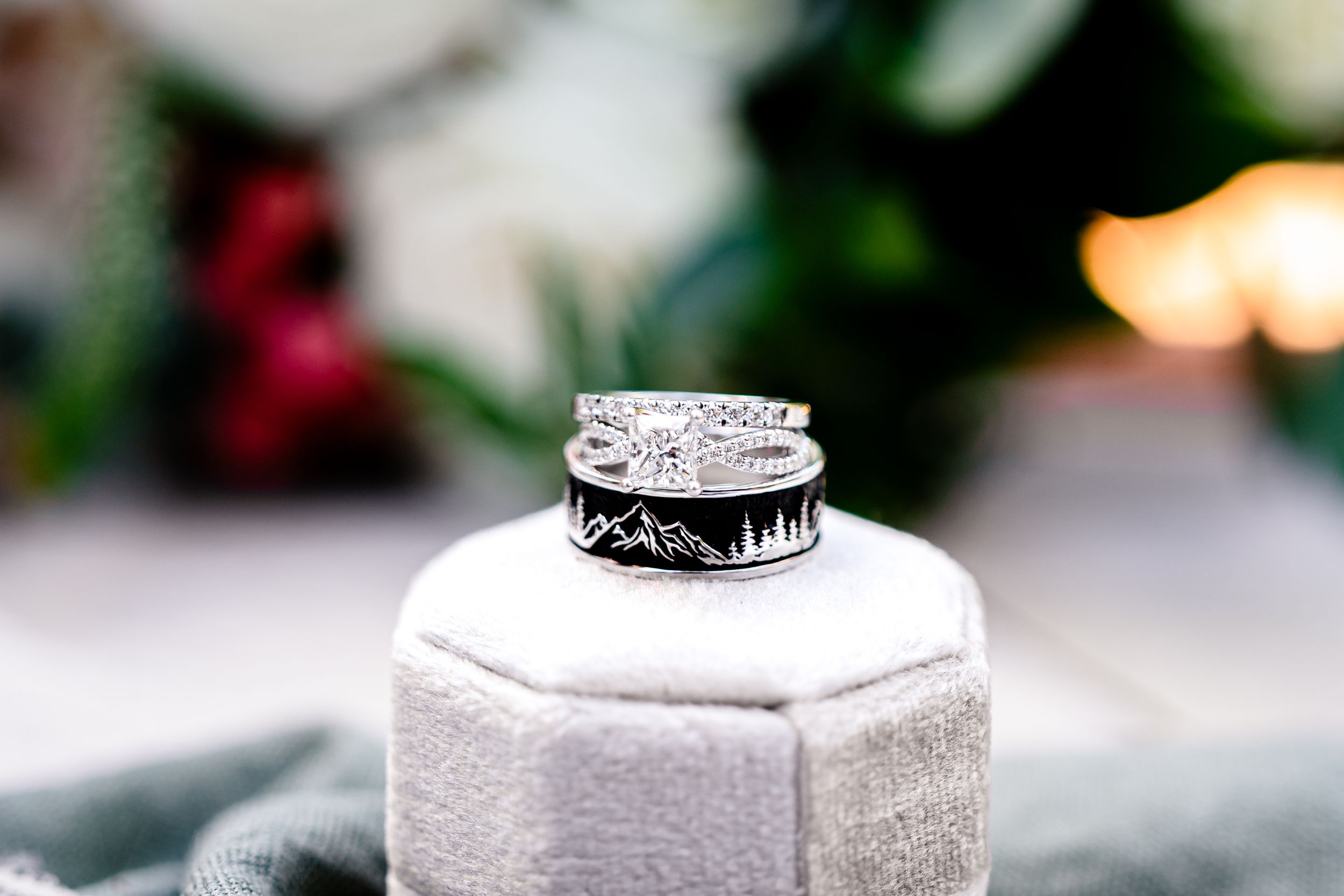 Close-up of elegant diamond wedding rings on white textured surface.