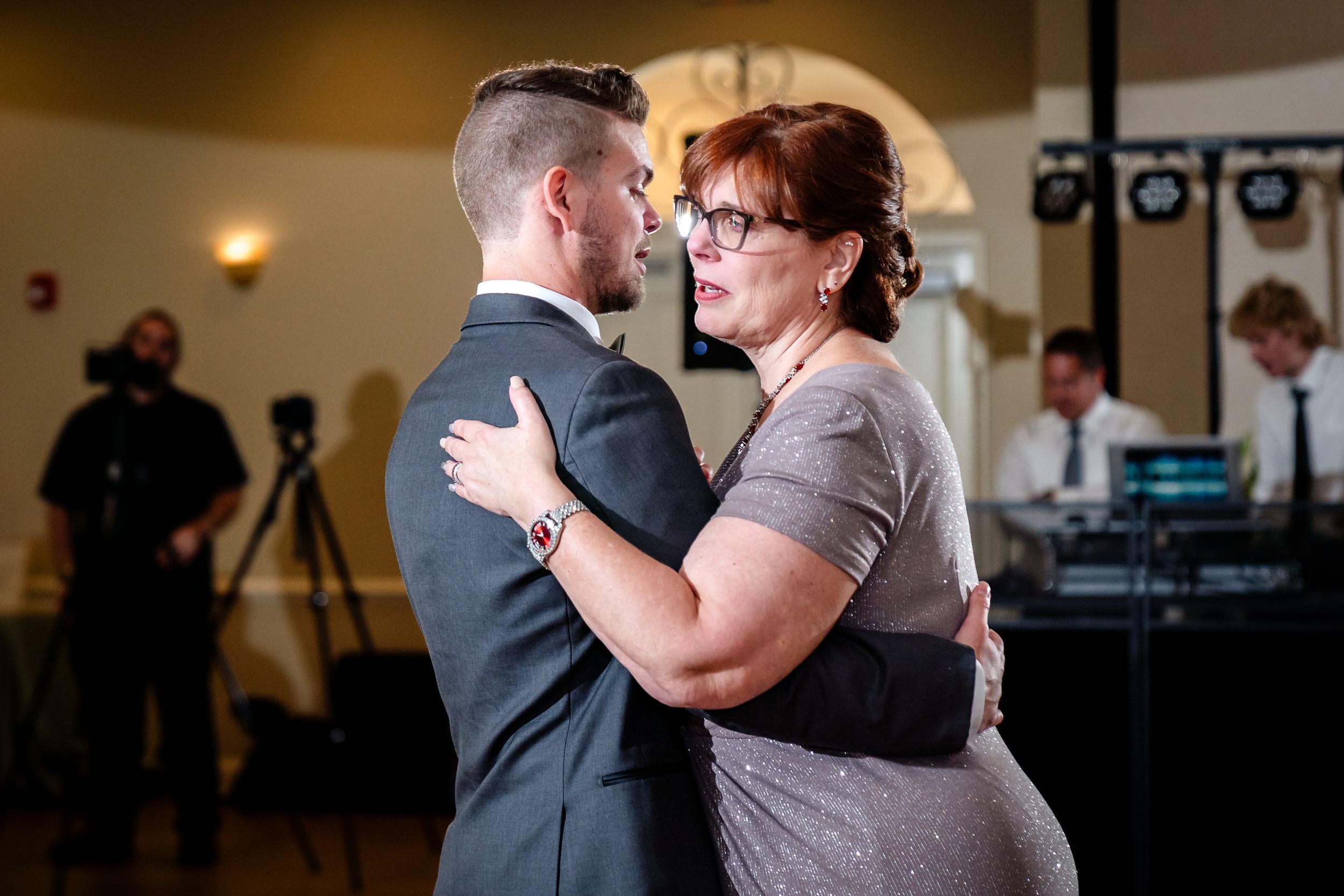 Special dance moment at a wedding reception with guests watching in the background.