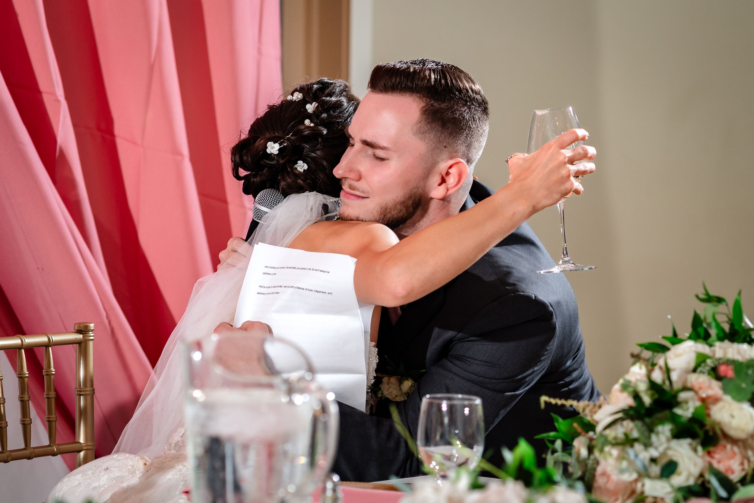 A tender embrace shared between newlyweds during their wedding reception.
