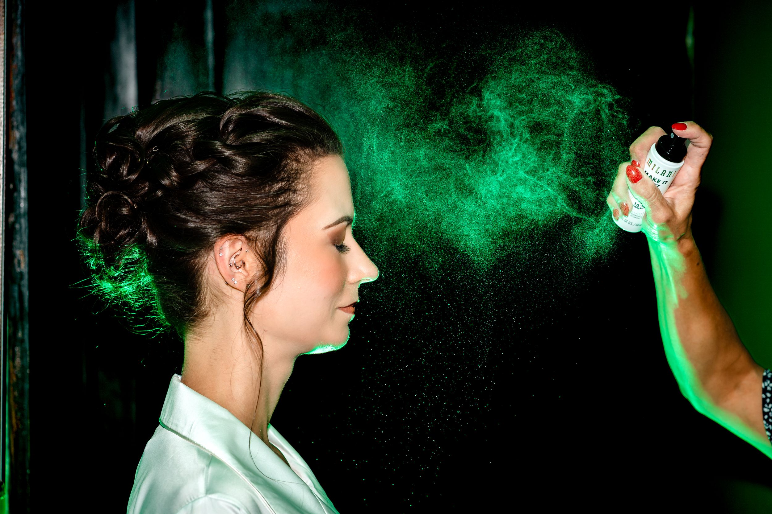 People posing against a dark background with green smoke effects.