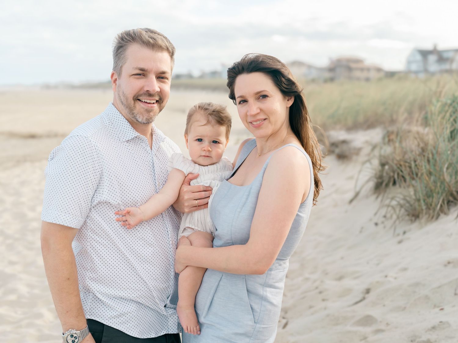 Parents with young one year old girl at the beach during Spring Lake NJ family photo session.