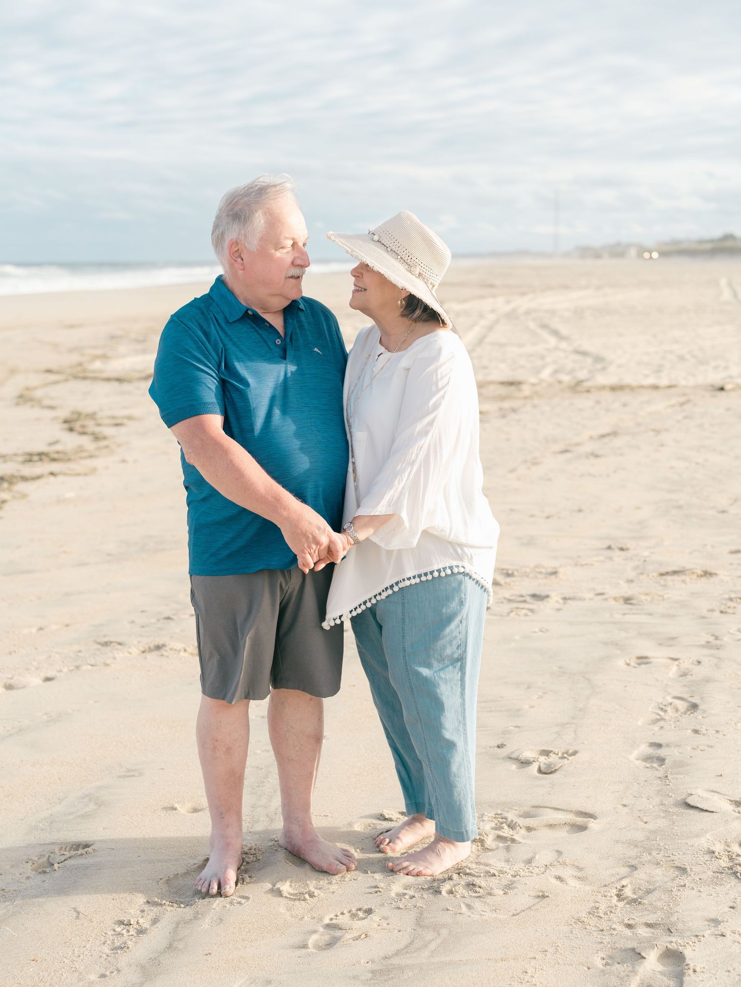 grandparents walking barefoot along the Spring Lake shoreline for an extended family session in Monmouth County NJ.