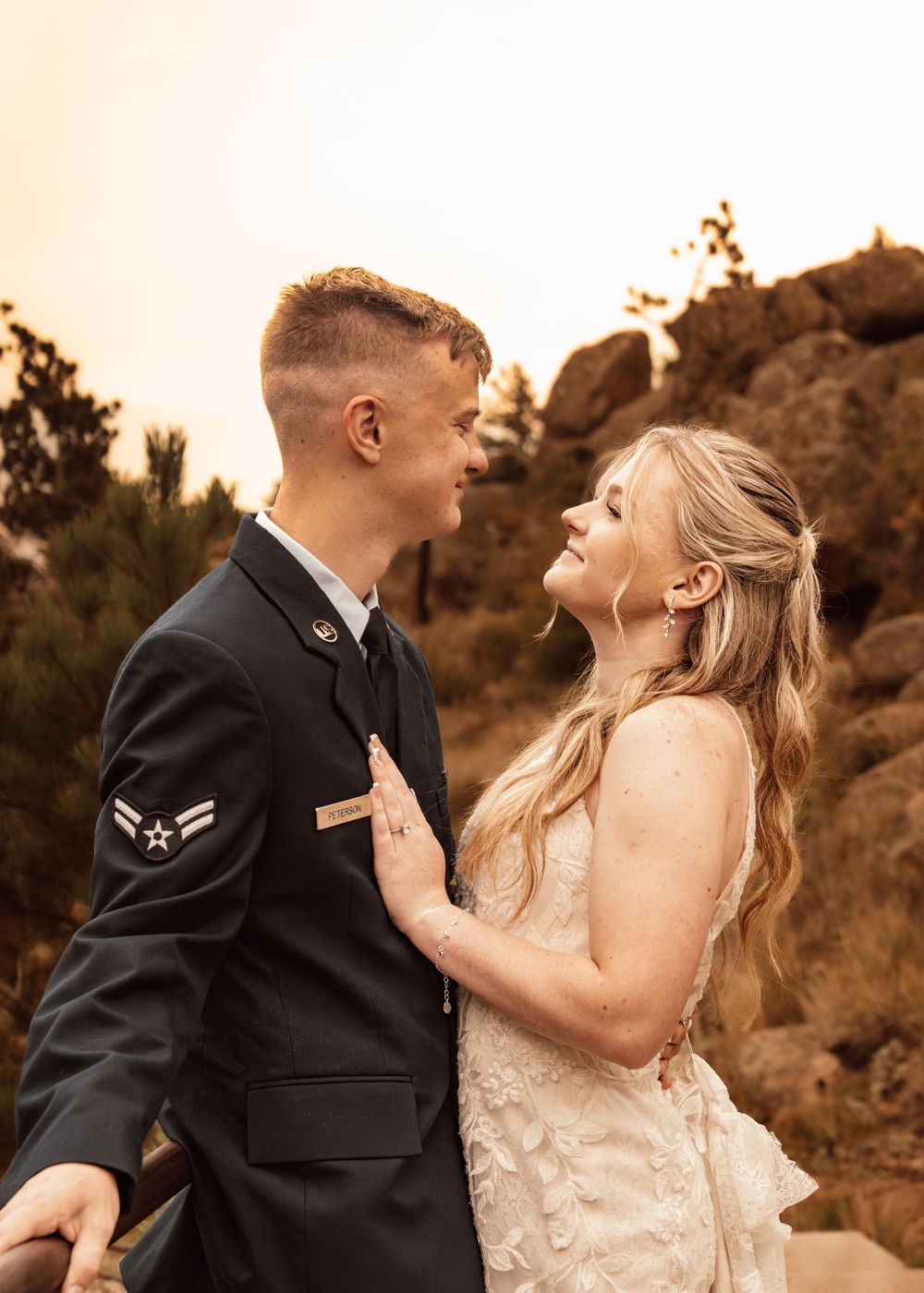 Candid wedding moments captured in sepia tones against rocky terrain.