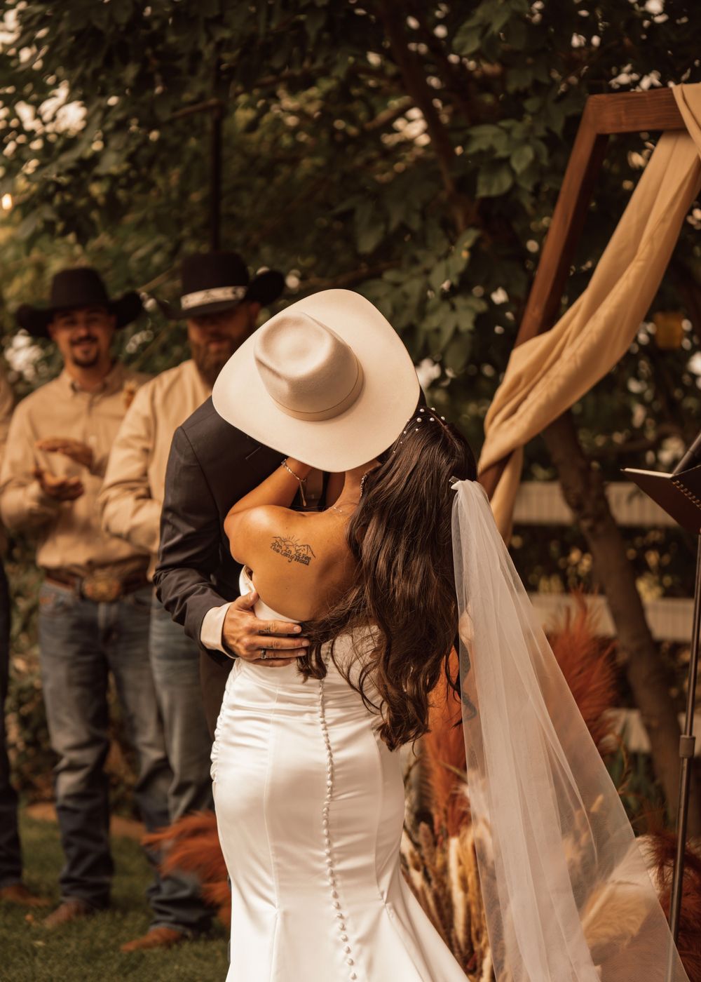 Intimate wedding moment captured during outdoor rustic ceremony.